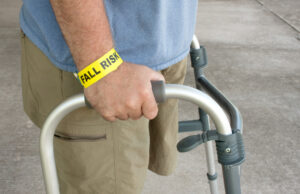 A nursing home resident wearing a fall risk wristband wonders if nursing home falls are considered neglect.