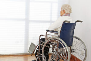 An older woman sits alone in a wheelchair and wonders how long she has to file a nursing home abuse claim in Georgia.
