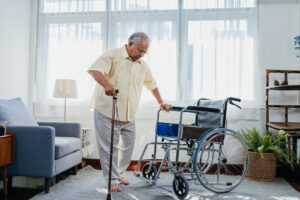 A man in a nursing home attempts to transfer to a wheelchair unassisted, which is one of the causes of most falls in nursing homes.